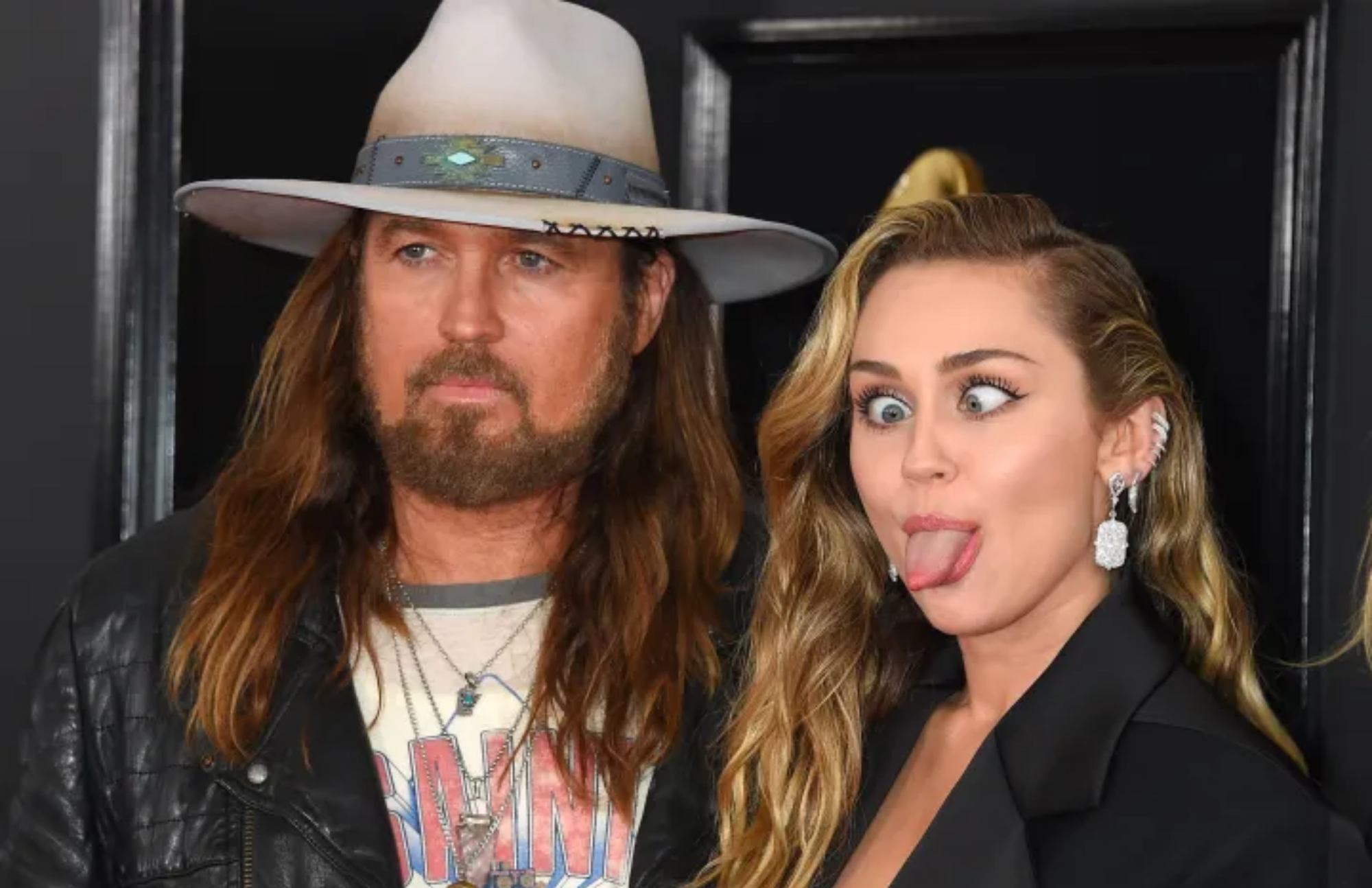 Miley Cyrus wacky pose with her father Billy Ray Cyrus wearing a cowboy hat