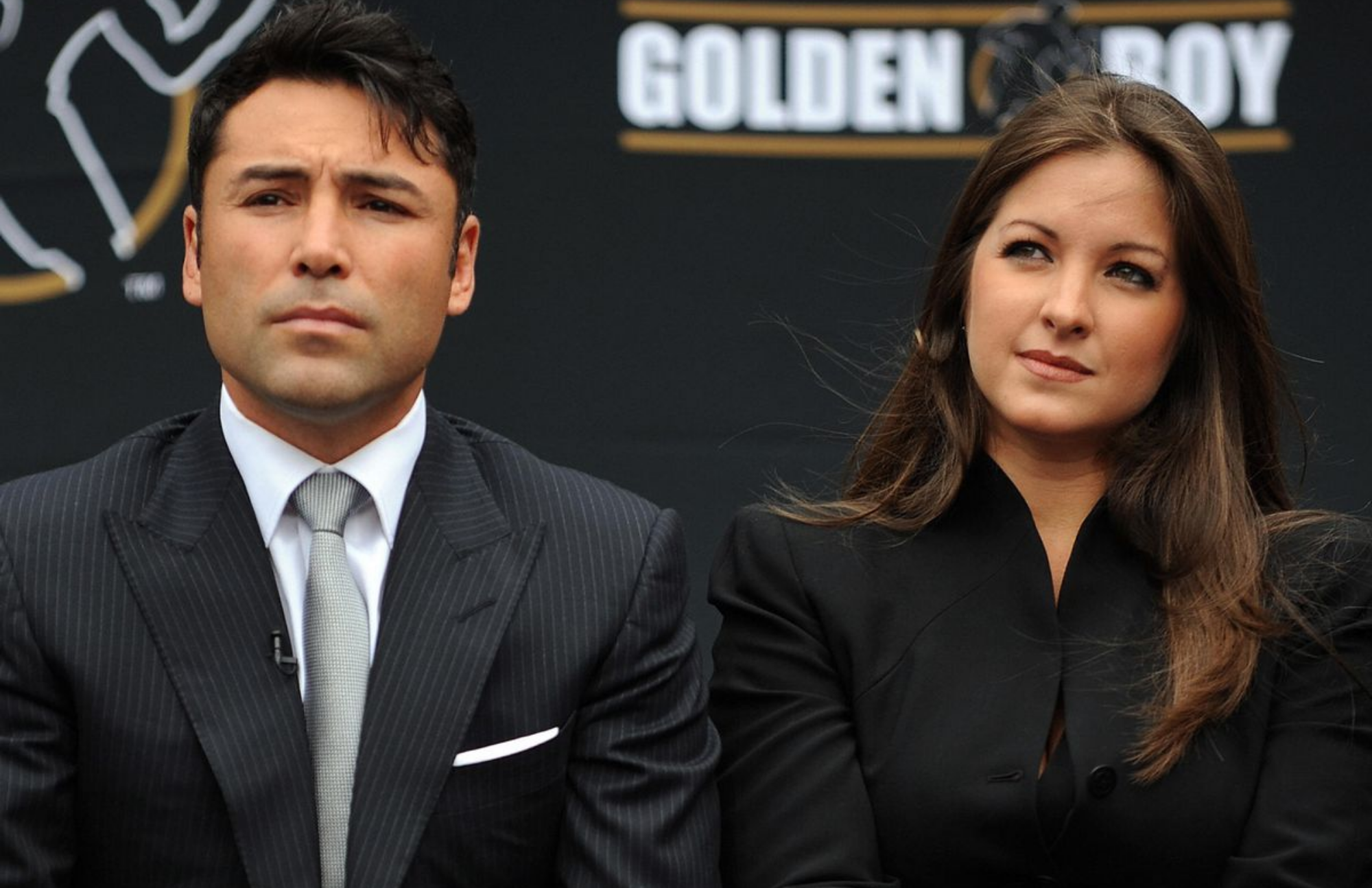 Oscar De La Hoya and his wife Millie Corretjer attend a meeting while dressed in black tops