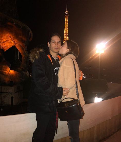 Sophie kissing her boyfriend with Eiffel Tower in the background