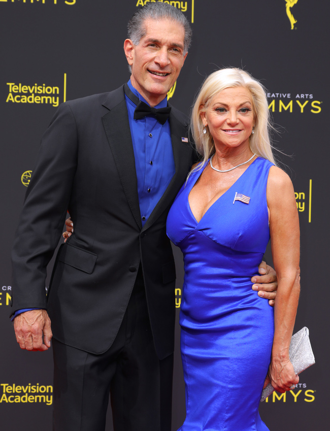 Julie Michaels wearing a royal blue dress with her husband, Peewee Piemonte, in the Emmy Awards night