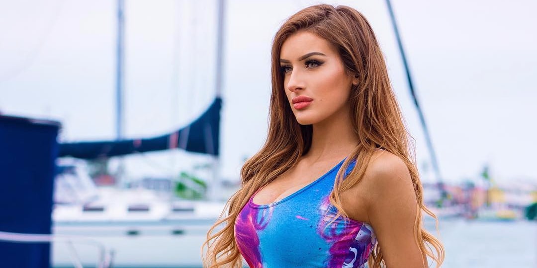 Molly Eskam wearing a colorful swimwear at a yacht port for a magazine shoot