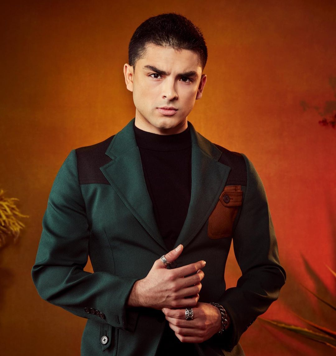 Diego Tinoco wearing a statement suit and posing for a magazine feature