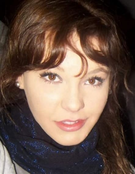 Manuela Escobar headshot wearing a glittery blue velvet scarf