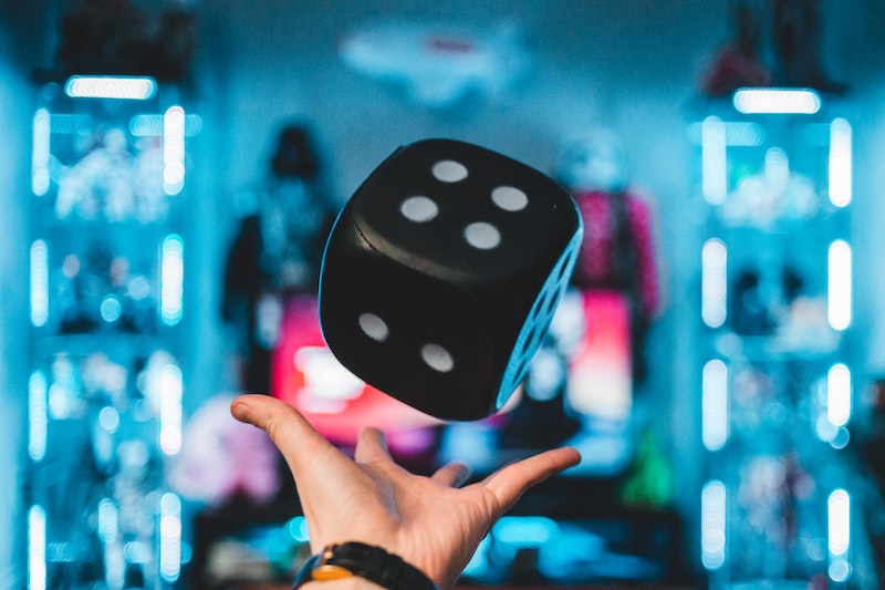A dice being thrown by hand