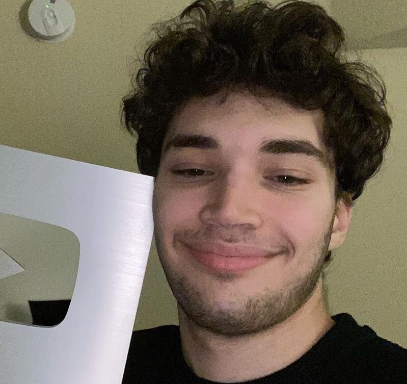 Adin Ross taking a selfie with youtube Silver plaque