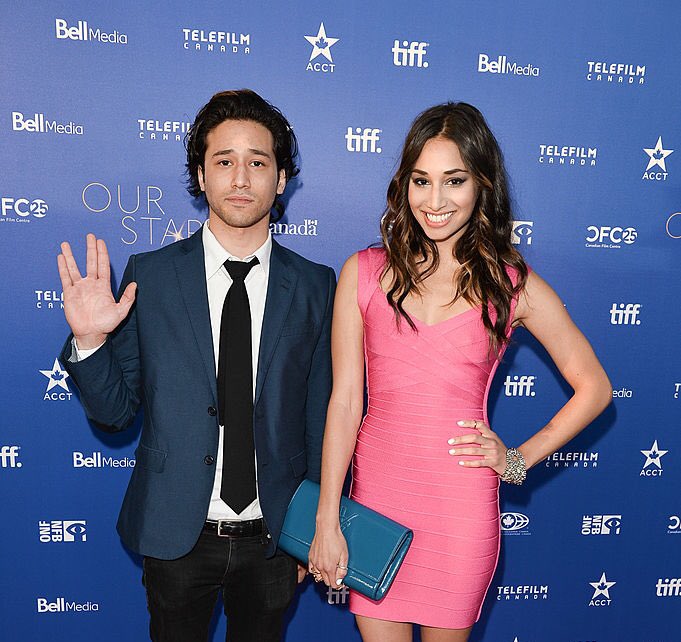 Jesse Rath standing with sister in a blue suit