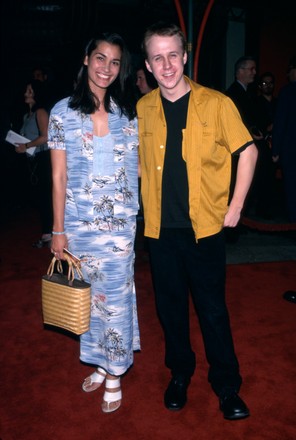 Benjamin salisbury standing with wife wearing a mustard shirt and black pants
