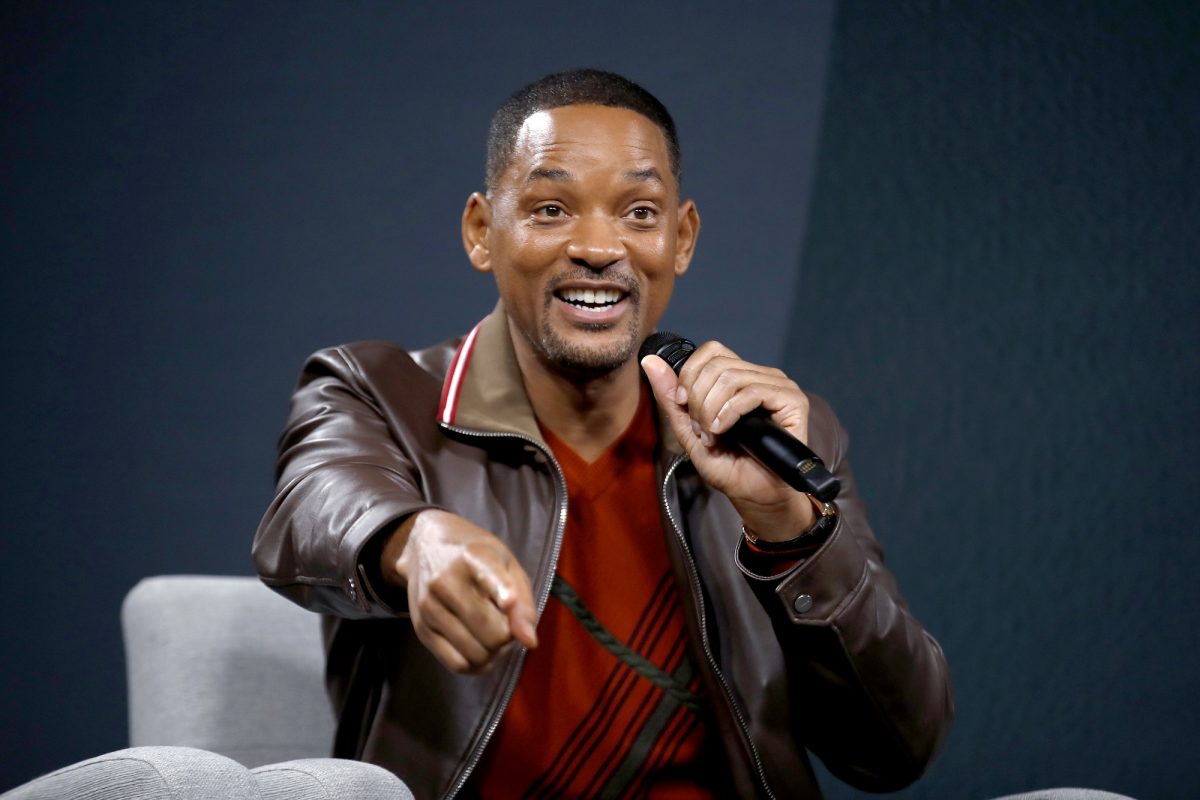Will Smith pointing while holding a mic