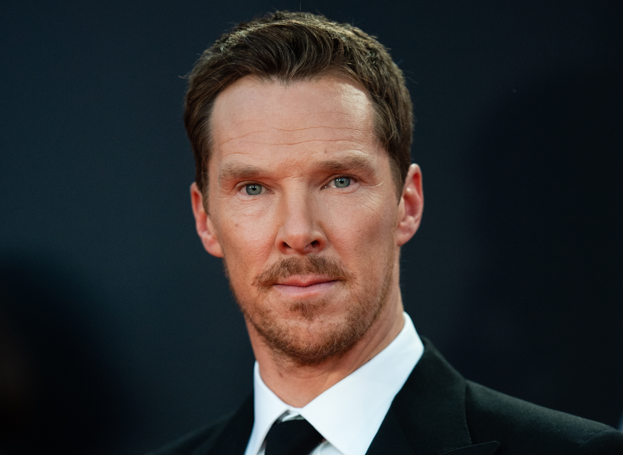 Benedict Cumberbatch wearing a suit attending an event
