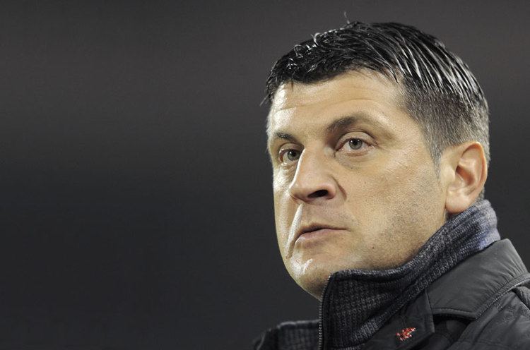 Vladan Milojevic wearing a black jacket with an serious facial expression