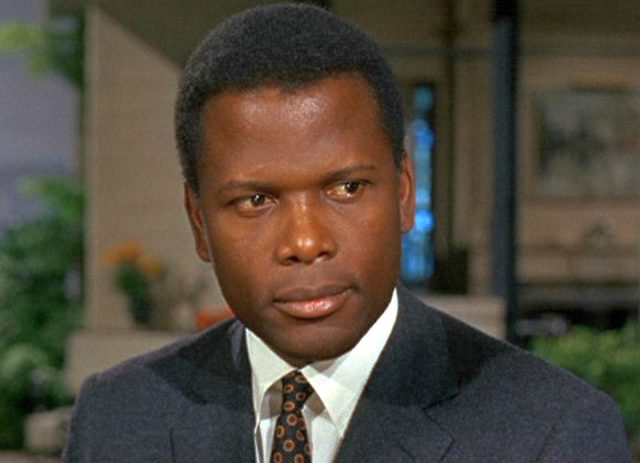Sydney Poitier in a gray suit