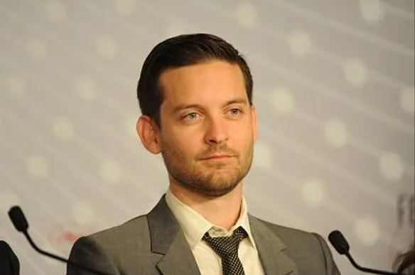 Tobey Maguire wearing a brow suit on stage