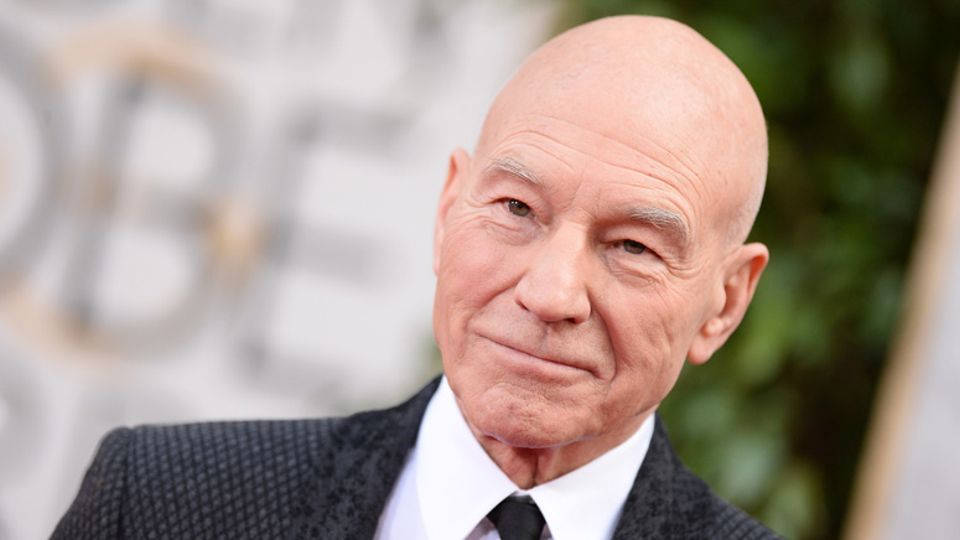Patrick Stewart wearing a suit in an event