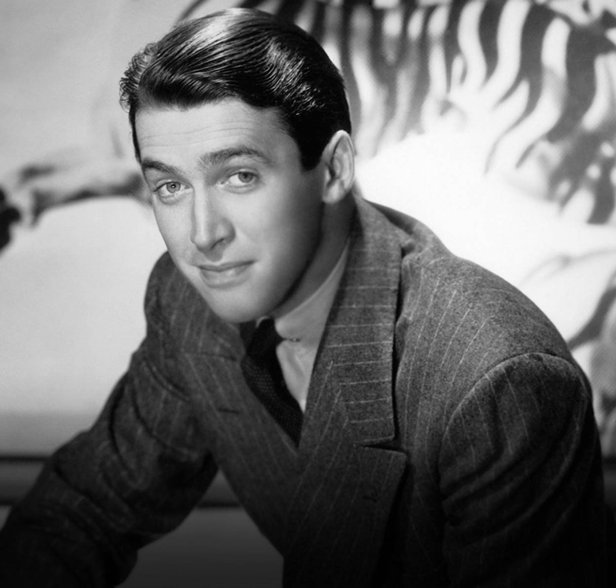 James Stewart in stripped coat and combed back hair