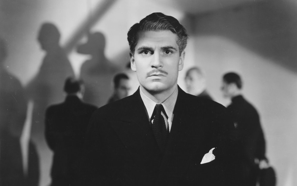 Laurence Olivier looking straight ahead wearing a suit