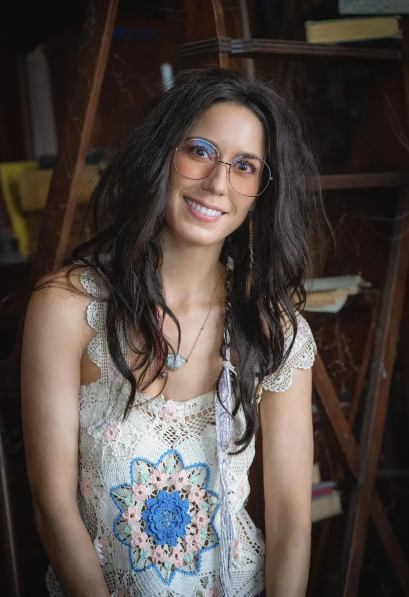 Sheila Carrasco Of Ghosts In A Crochet Shirt And Round Glasses