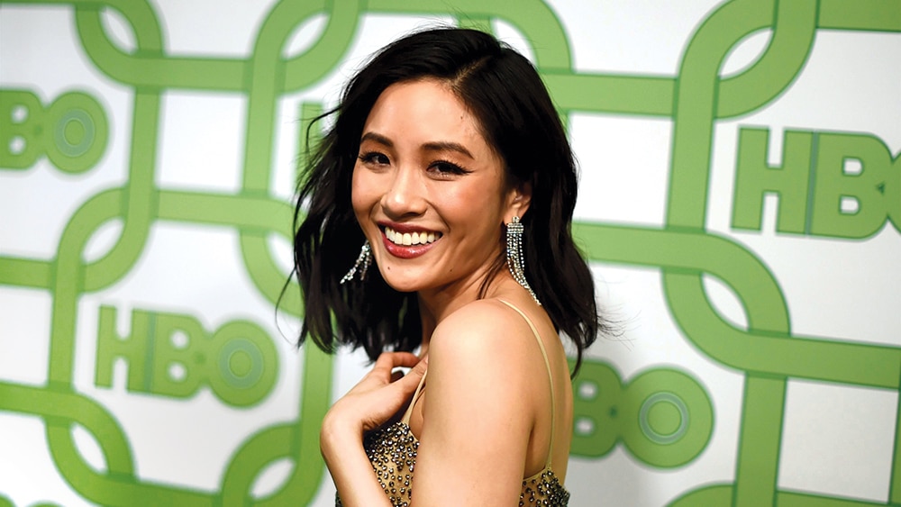 Constance Wu wearing a golden dress at HBO event