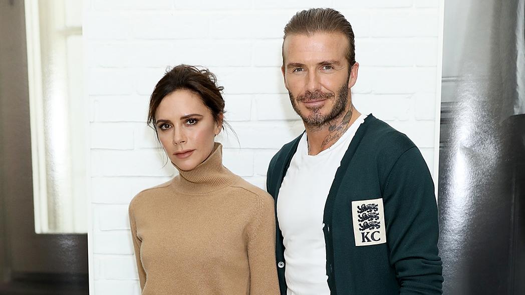 Victoria Beckham wearing a skin dress and David Beckham wearing a blue-green jacket on a white shirt