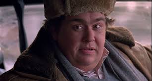John Candy In Russian Outfit Seated In A Car