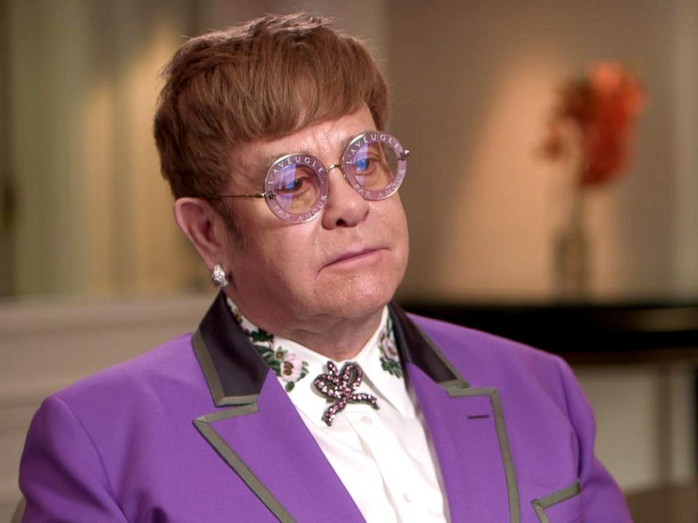 Elton John Wearing A Purple Suit