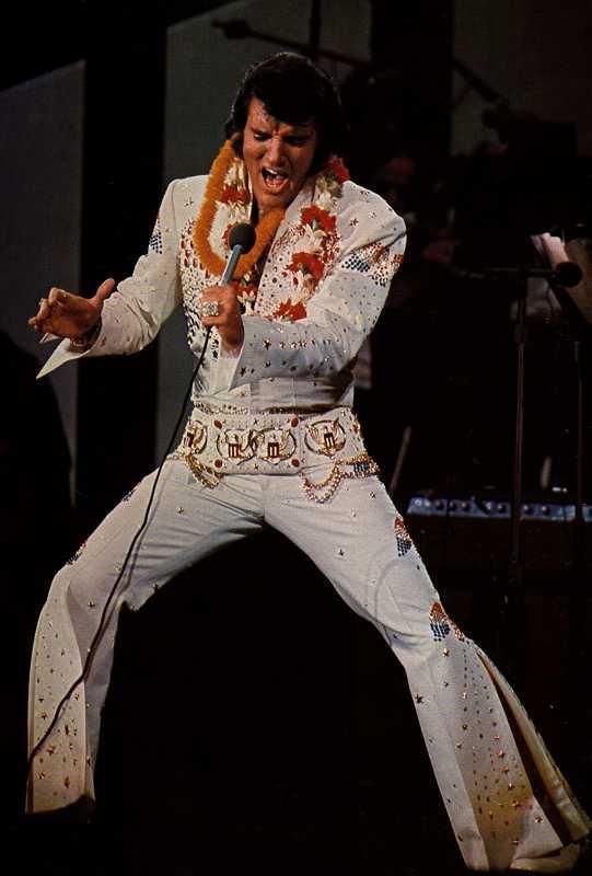 Elvis Presley Singing wearing his iconic white costume