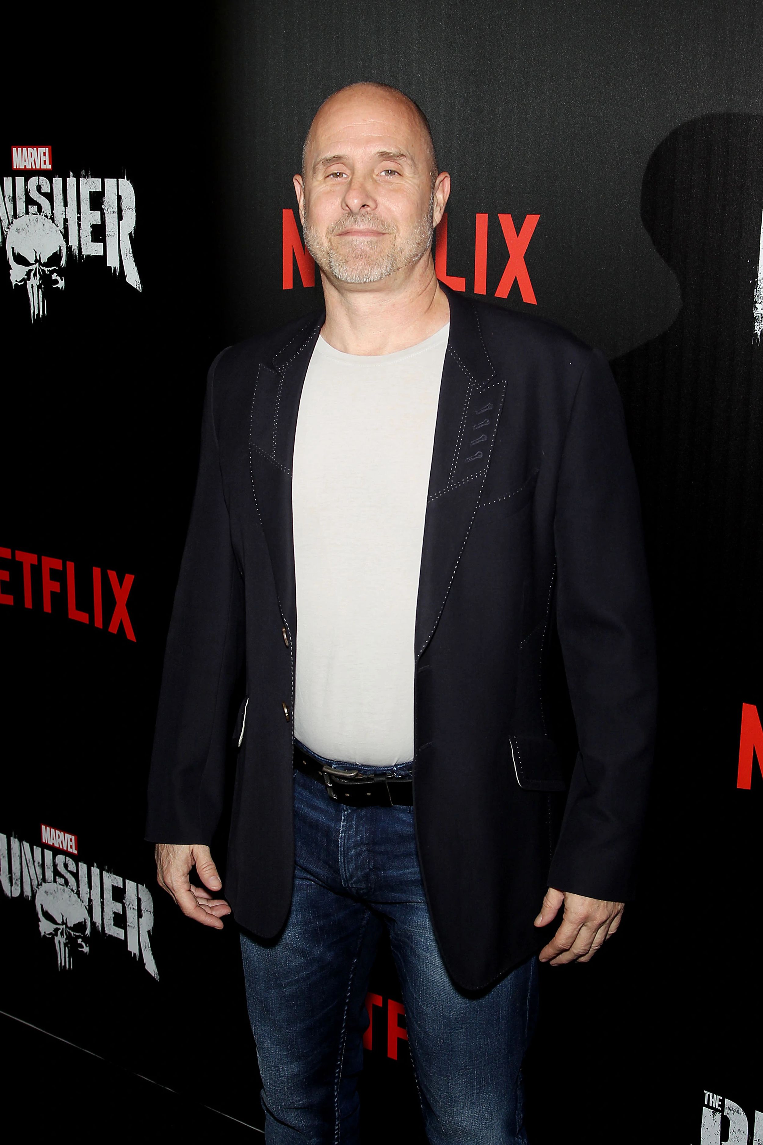 Paul Schulze wearing a suit and a jean at Netflix premier