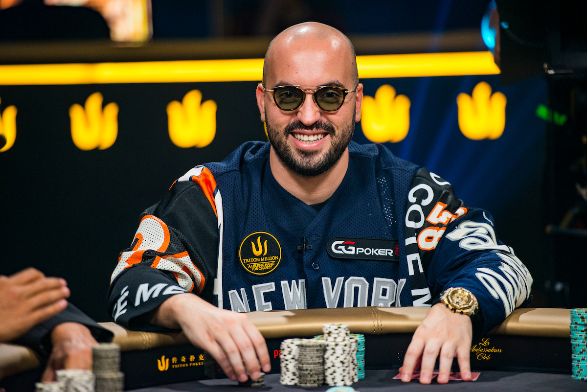 Bryn Kenney wearing a poker jersey shirt and sunglasses while playing poker