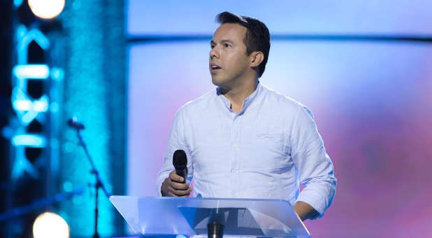 Samuel Rodriguez Holding A Mic during a Conference 