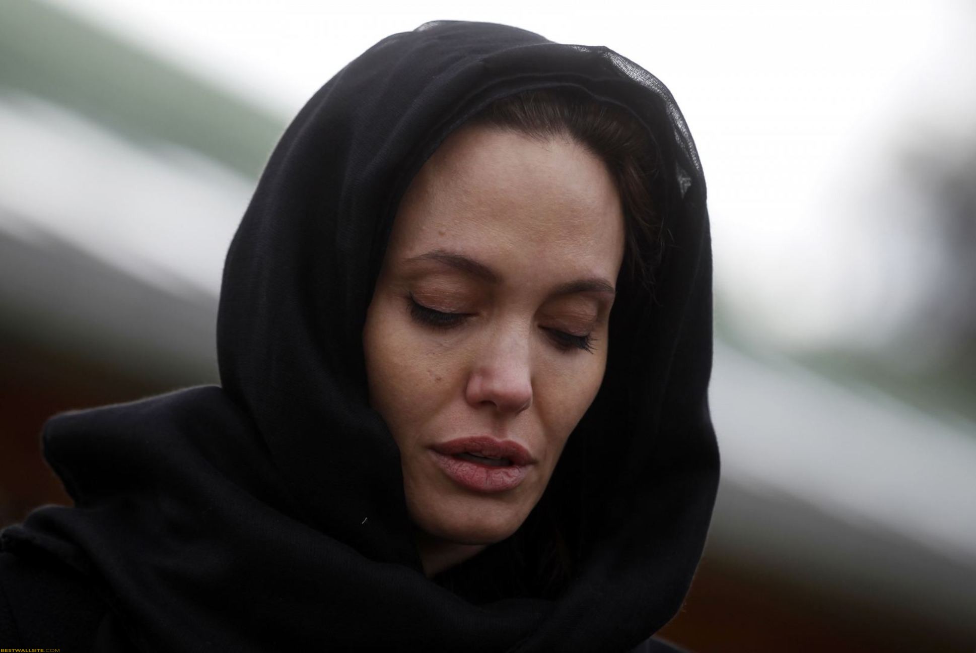 Angelina Jolie wearing a black scarf with no makeup at United Nation event