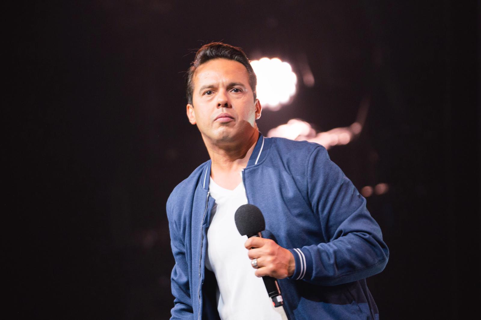 Samuel Rodriguez In Blue Jacket Holding A Mic