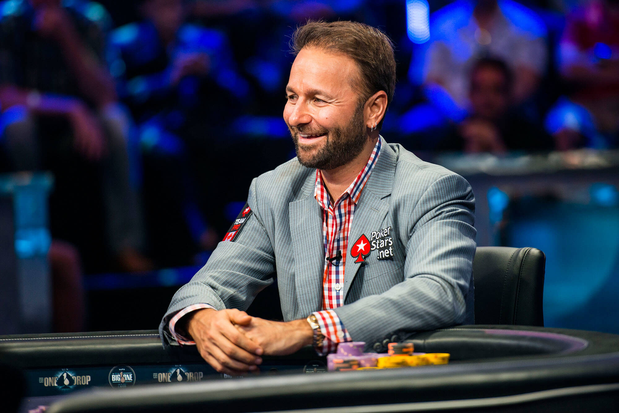 Daniel Negreanu wearing a suit while playing poker