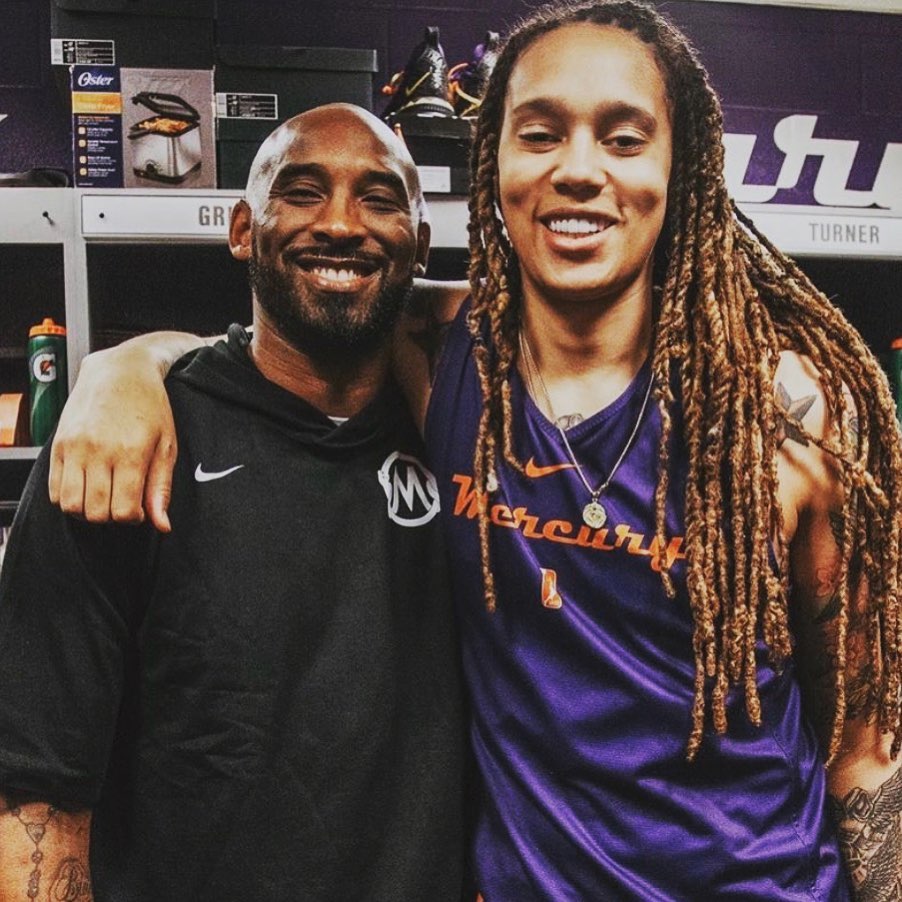 Kobe Bryant and Brittney Griner, in her Phoenix Mercury jersey, put their arms on each other