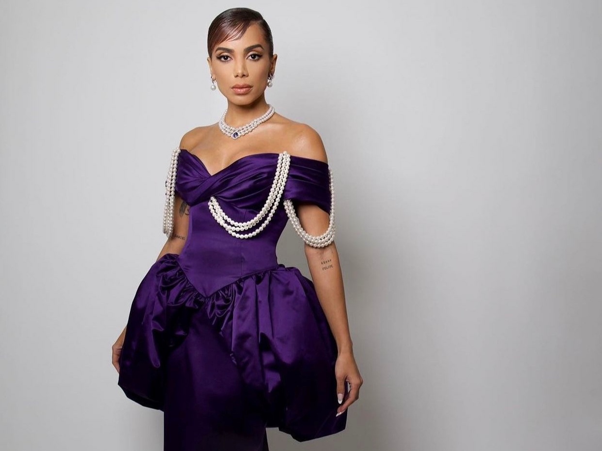 Anitta wearing a purple beaded dress