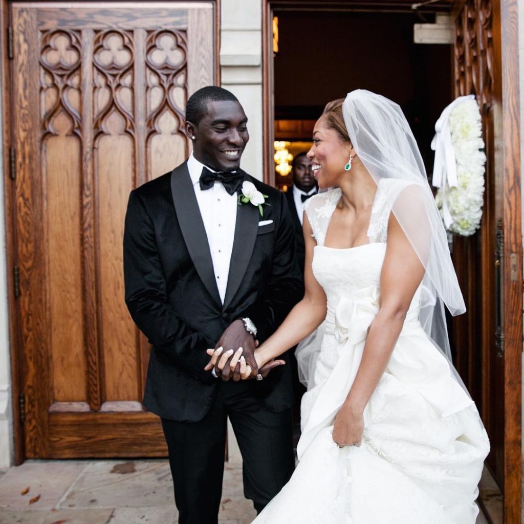 Morgan Harvey with her husband Kareem in their wedding dresses