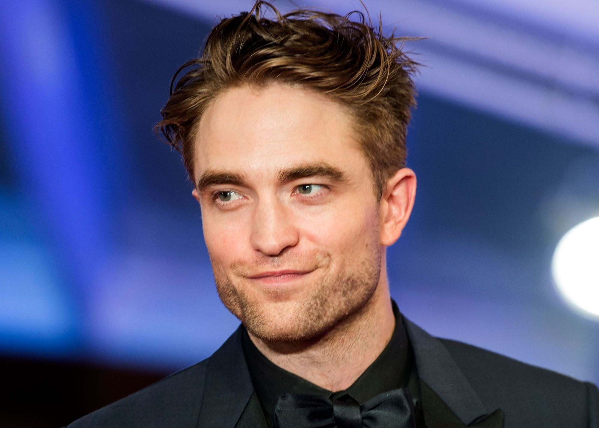 In his formal attire, Robert Pattinson wears a bowtie and a friendly smile