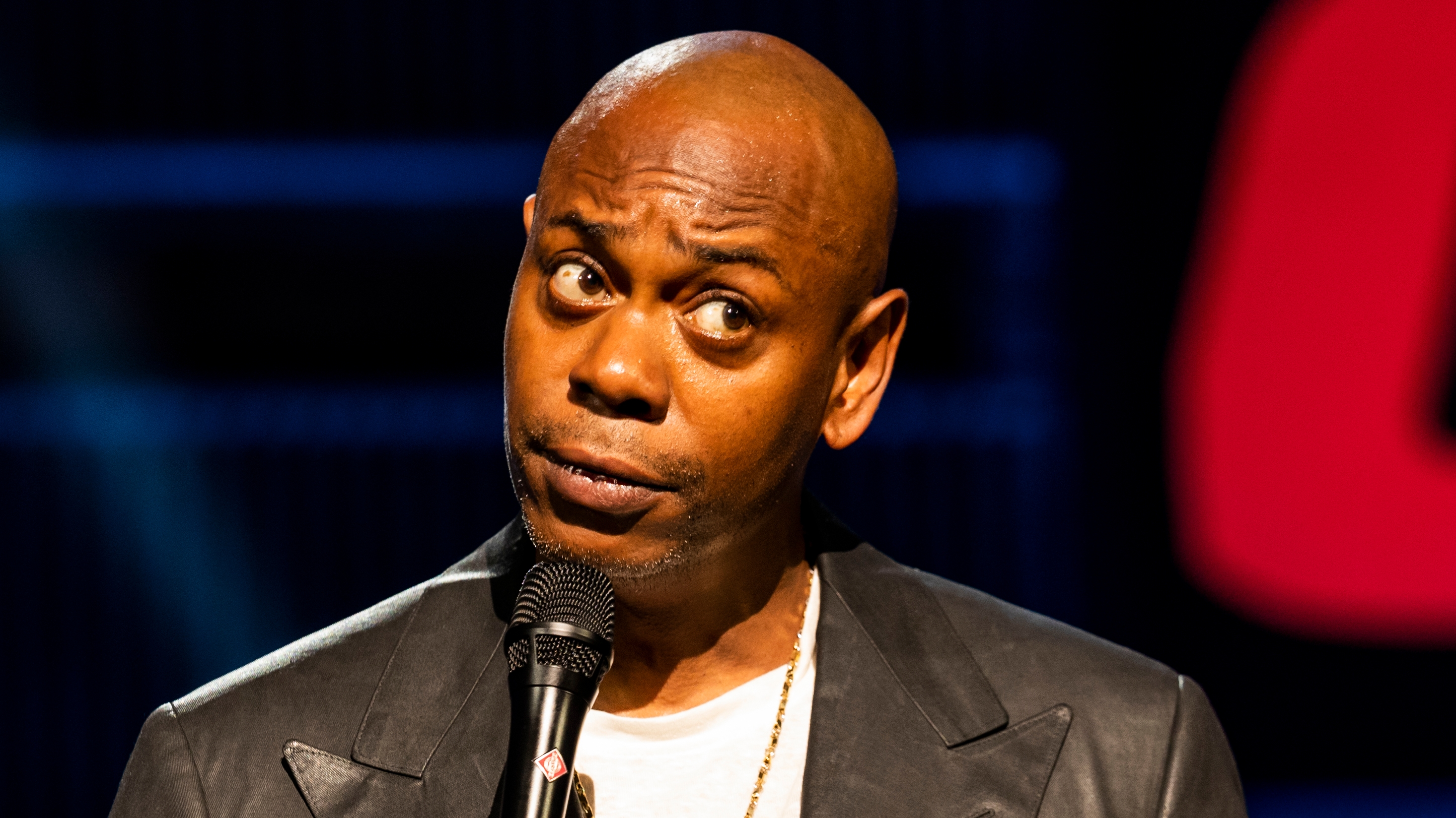 Dave Chappelle holding a mic