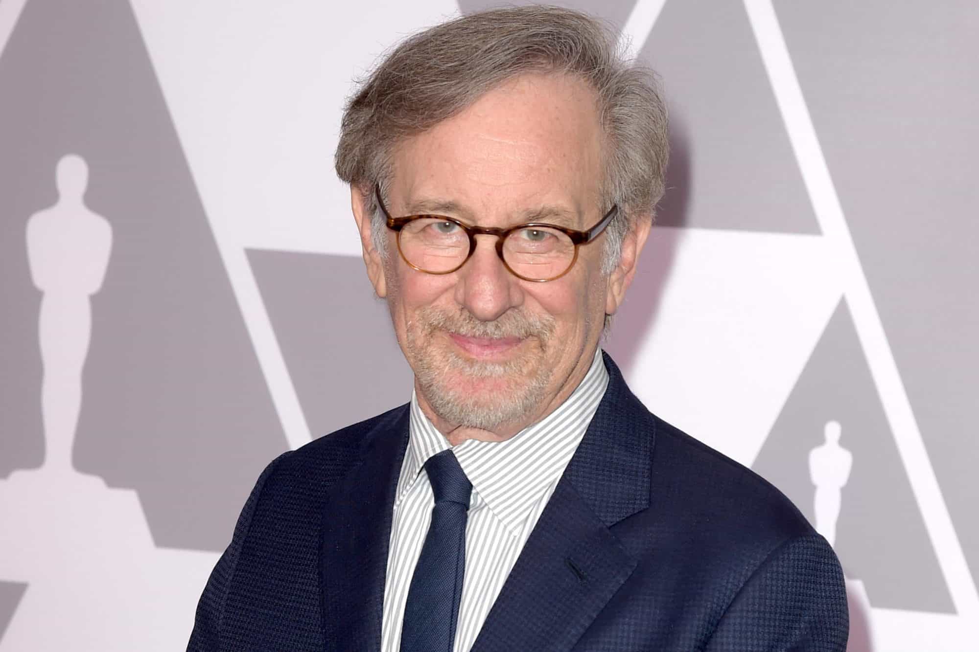 Steven Spielberg wearing a blue coat and eyeglasses