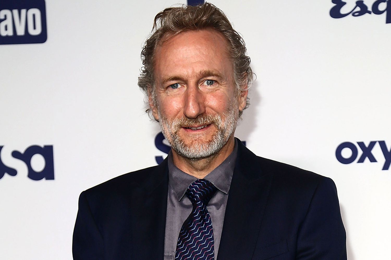 Brian Henson wearing a black suit