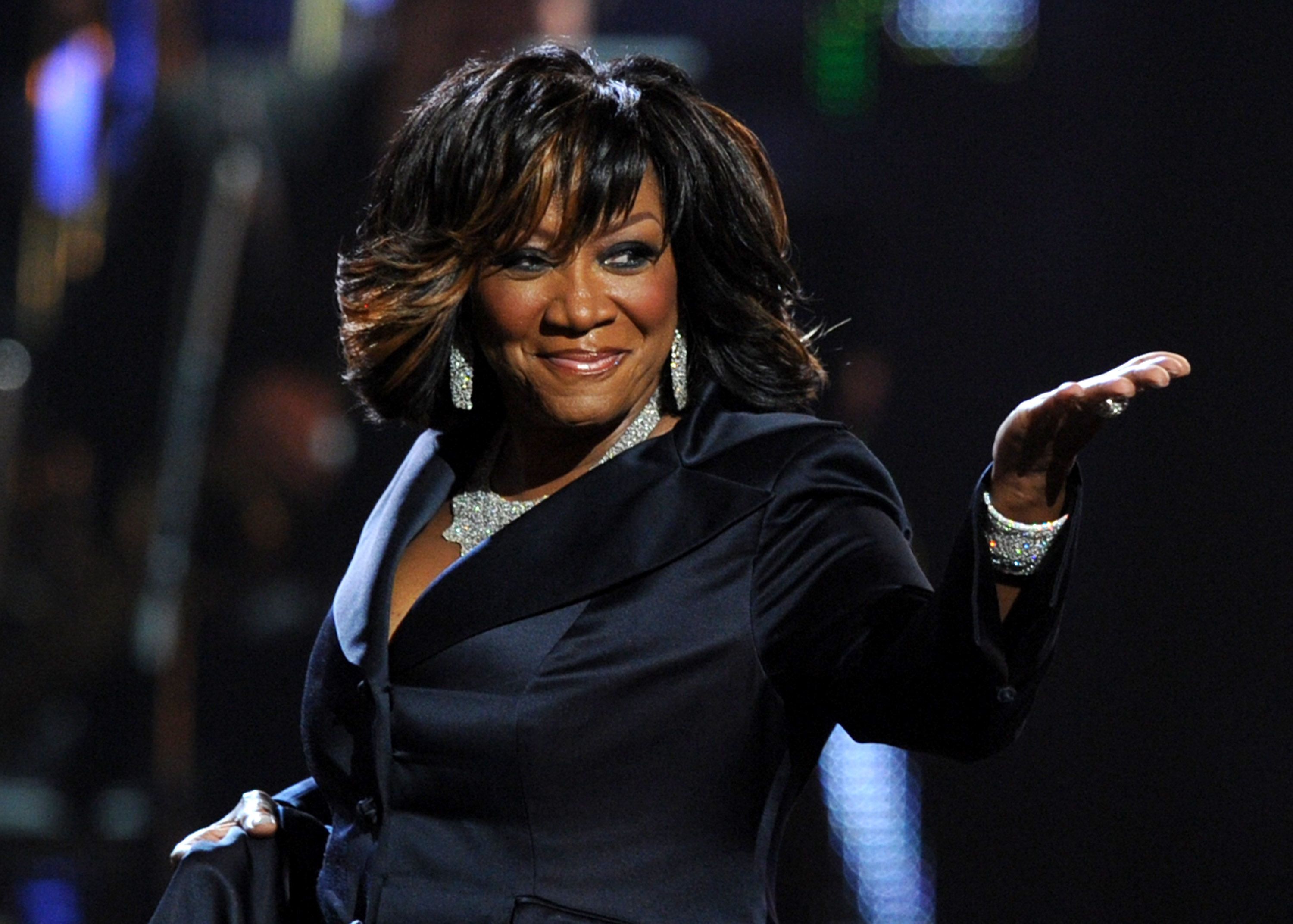 Smiling Patti Labelle wearing a black coat