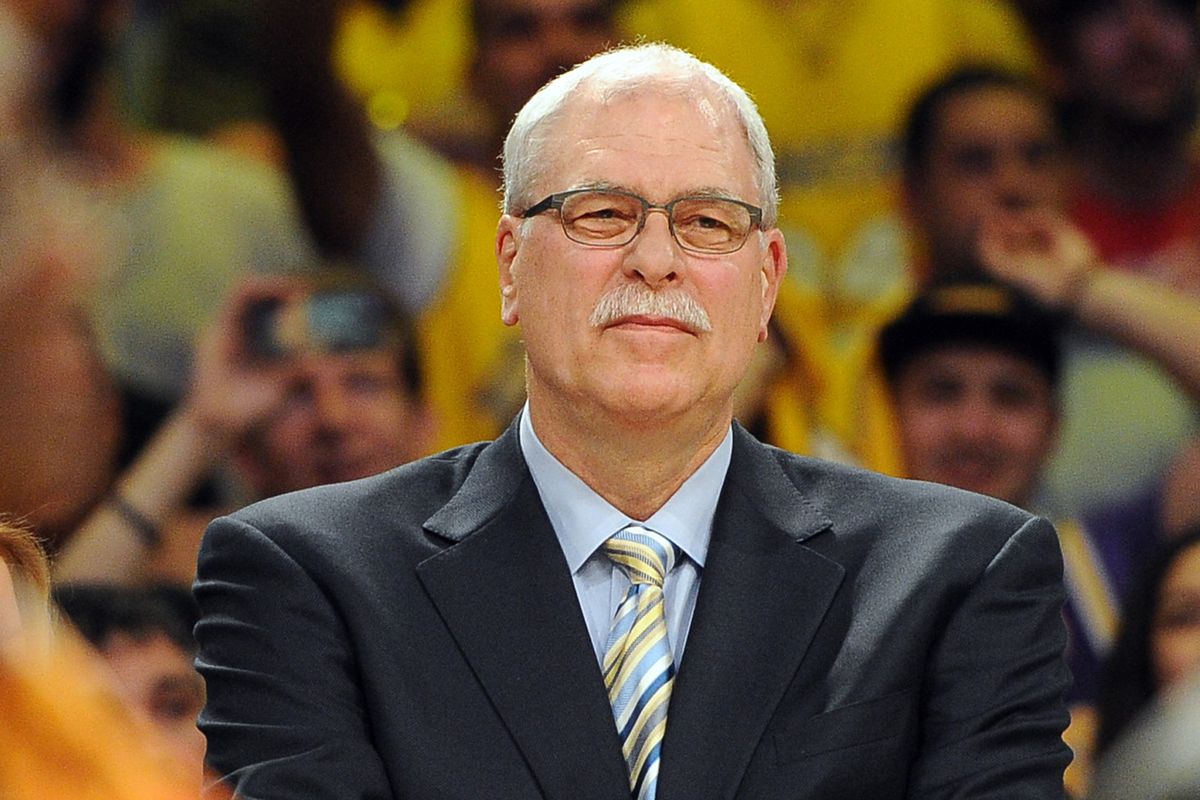 Phil Jackson wearing a suit and eyeglasses