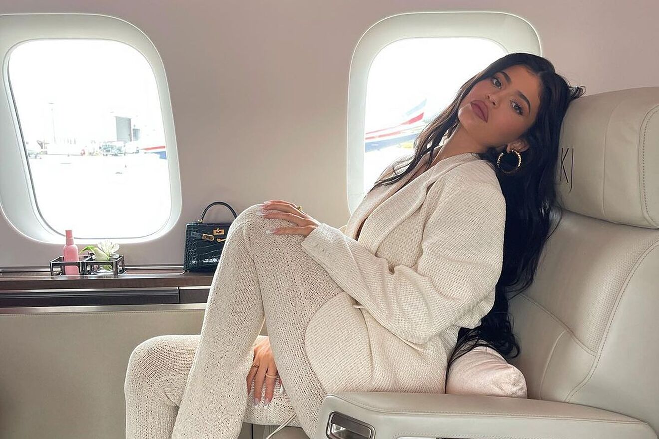 Kylie Jenner wearing a knitted white outfit aboard her private plane