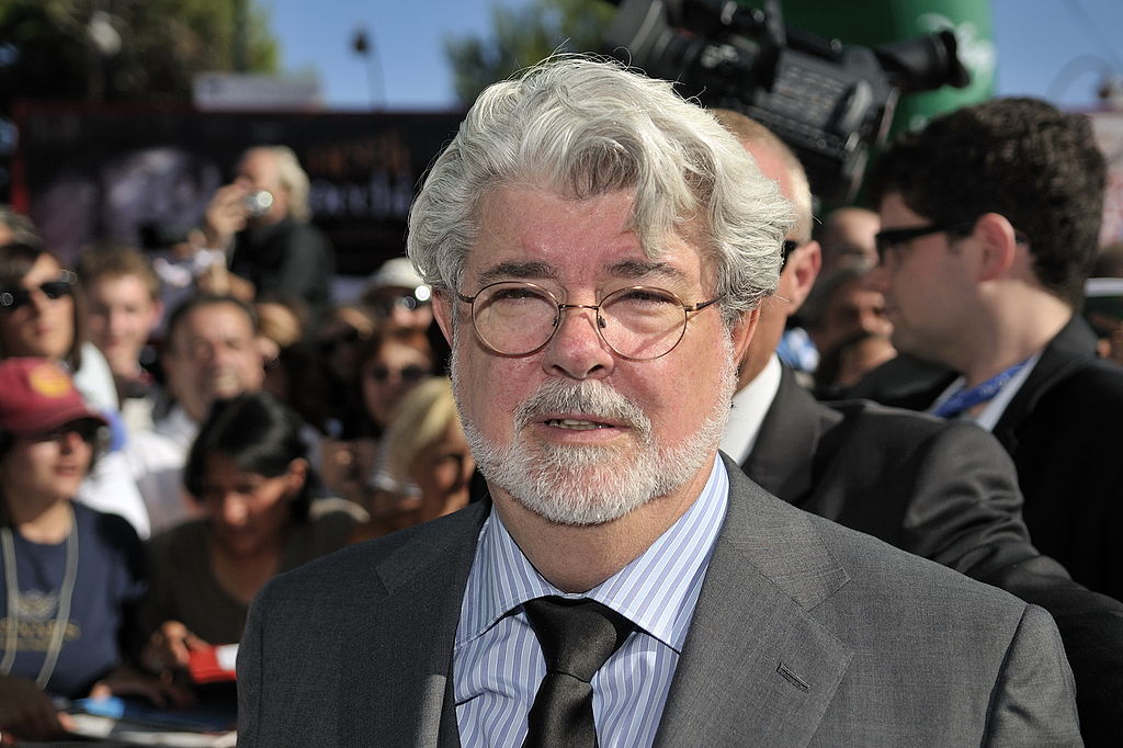 George Lucas wearing a gray coat and eyeglasses