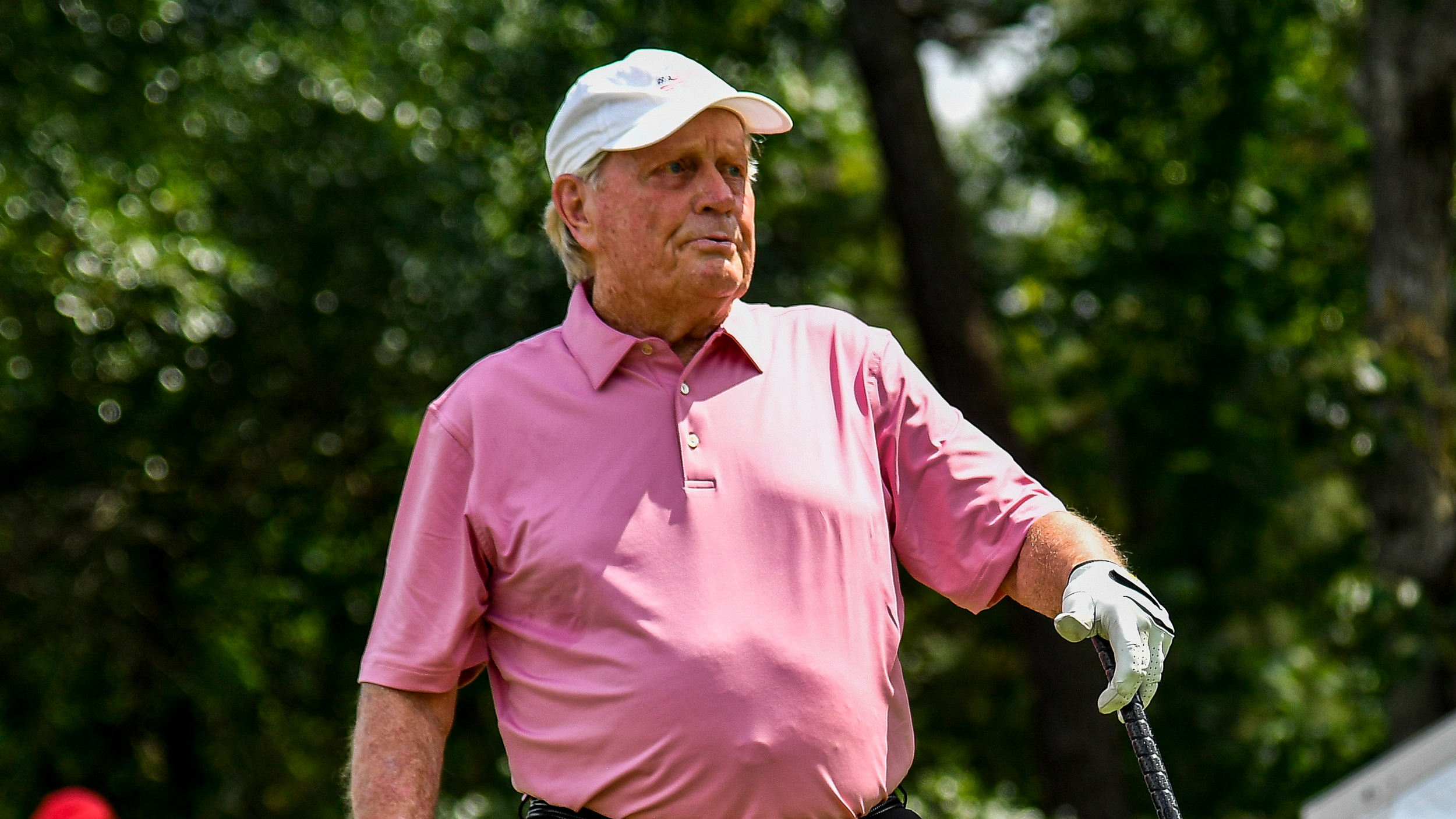 Jack Nicklaus wearing a pink polo shirt and white cap
