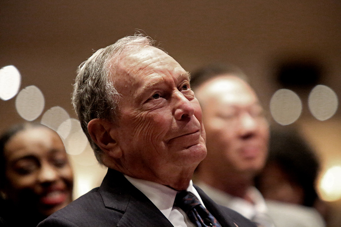 Smiling Michael Bloomberg wearing a black suit
