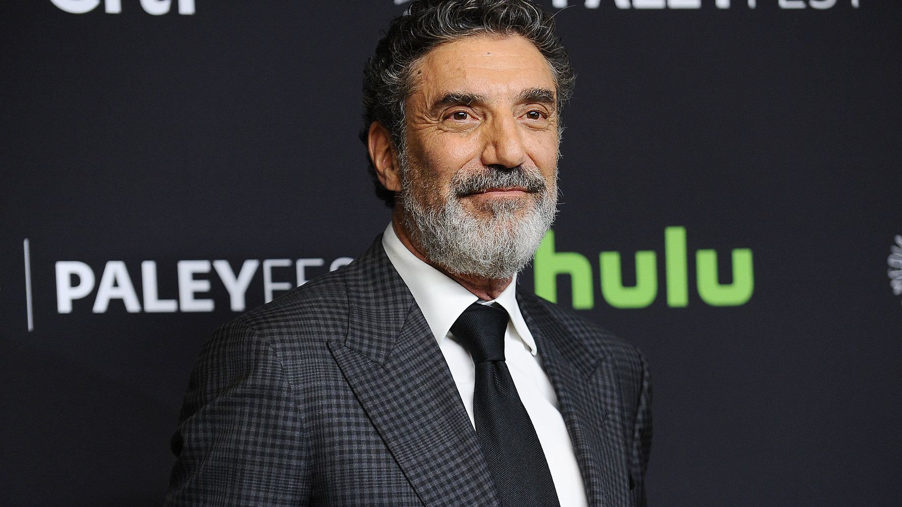 Chuck Lorre wearing a black checkered coat