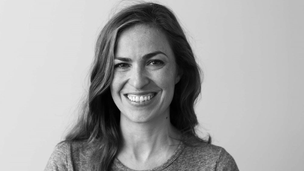 A headshot of Lisa Brennan Jobs with a big smile