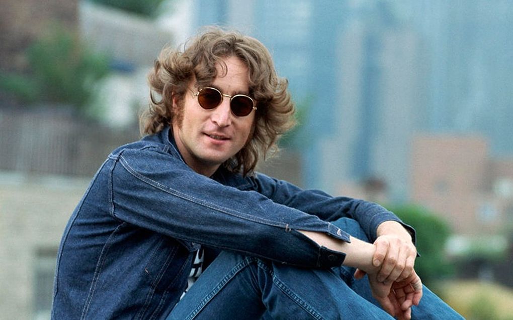 John Lennon wearing a denim jacket and pants with sunglasses