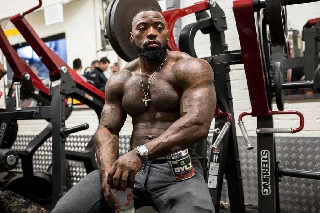 Mike Rashid wearing  a gray sweatpants while holding a drink