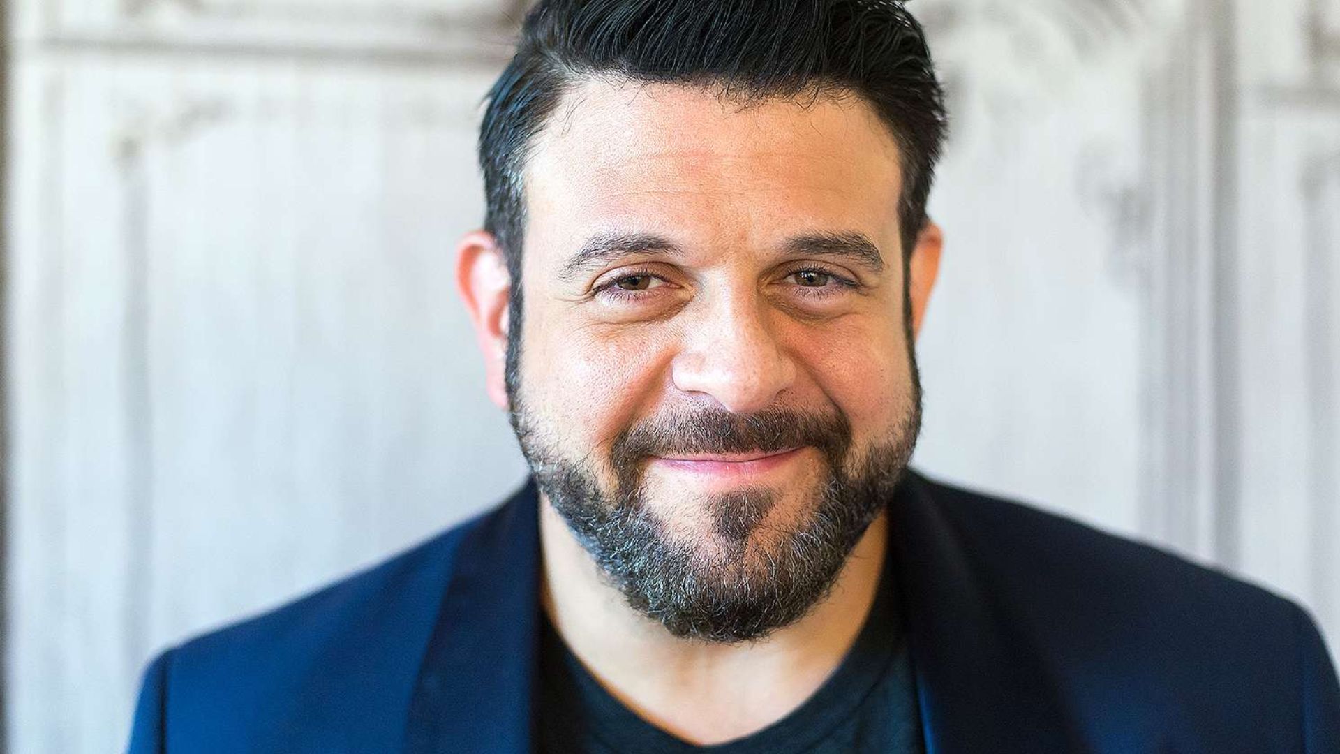 Adam Richman With Eyes Half Closed And Smiling With Lips