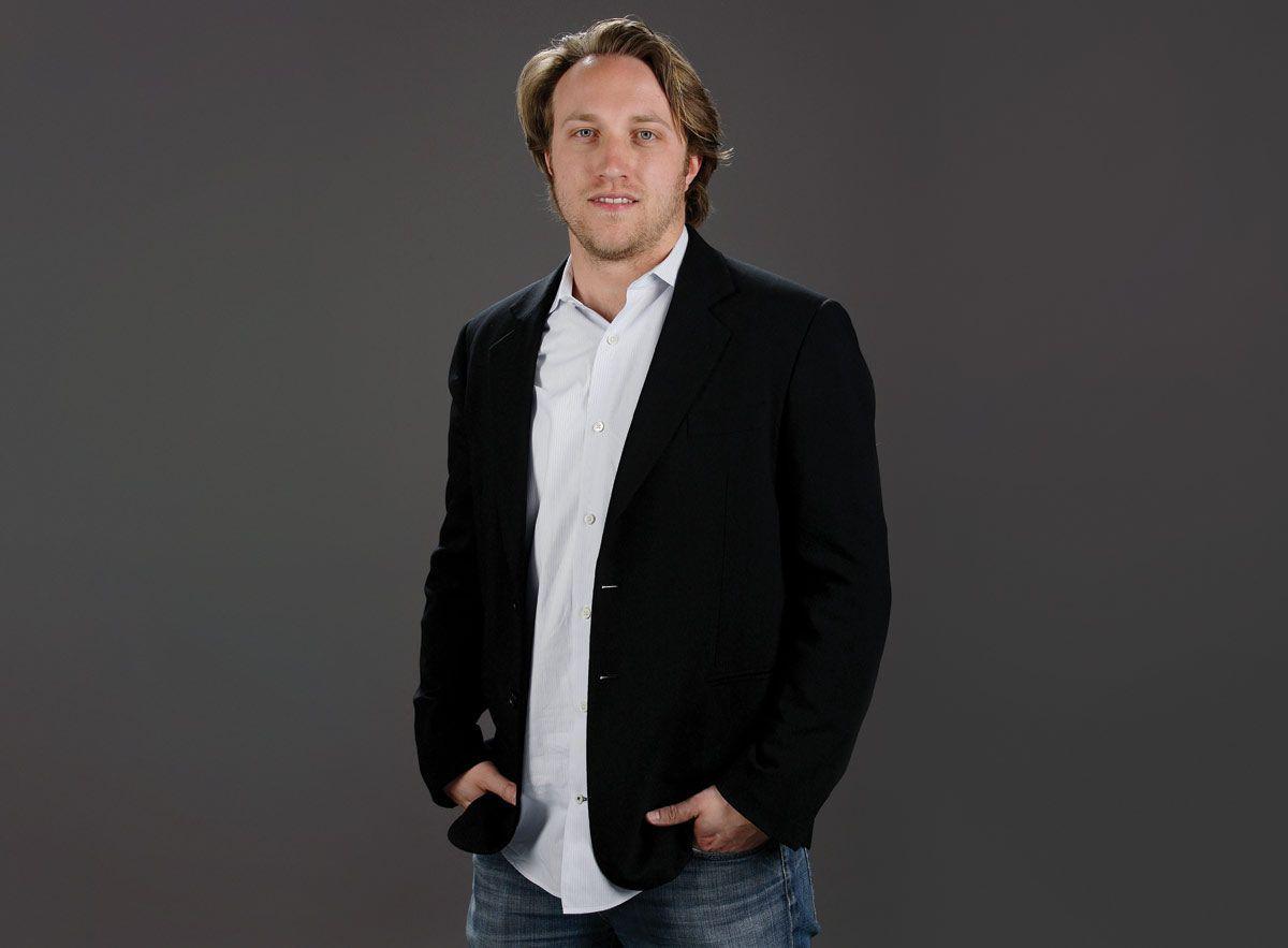 Chad Hurley wearing a black coat with his hands on his pockets